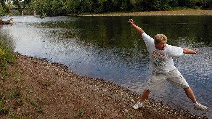 Russ Byars skips a stone at the Riverfront Park in Franklin, Venango County. Mr. Byars was recognized by Guinness World Records as the stone-skipping record holder with 51 skips.