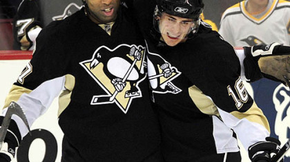 Penguins Georges Laraque congratulates teammate Erik Christensen after scoring against the Islanders in the first period last night.