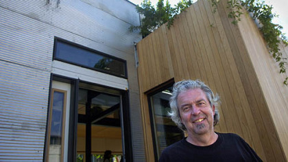 Stephen Lee, professor at Carnegie Mellon University's School of Architecture, stands yesterday in front of CMU's Solar Decathlon house at Construction Junction in Point Breeze.