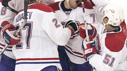 Montreal's Andrei Markov is mobbed by teammates after scoring the winning goal in the eighth round of the shootout at Mellon Arena.
