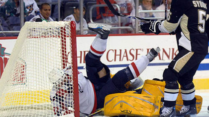 Washington Capitals' Michael Nylander, left, of Sweden, falls over Penguins goalie Marc-Andre Fleury as Darryl Sydor (5) looks on during the first period last night in Washington.