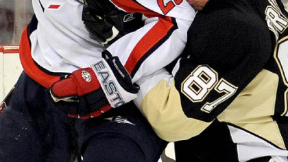 Sidney Crosby checks Shaone Morrison of the Washington Capitals in game last night at Mellon Arena.