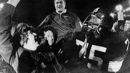 Steelers head coach, Chuck Noll, is carried off the field by his players led by defensive standout #75 Joe Greene. The Steelers won their third Super Bowl defeating the  Dallas Cowboys 35-31.
