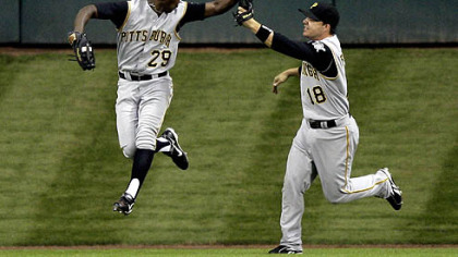 Pirates center fielder Nyjer Morgan (29) celebrates with teammate Steve Pearce (18) after catching a long fly ball hit by Houston Astros' Ty Wigginton with the bases loaded during the third inning of last night's game in Houston. Morgan made the catch for the final out of the inning.