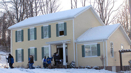 ABC's "Extreme Makeover: Home Edition" crew and construction workers exit Fairmont, W.Va., resident Richard Turner's house Thursday after applying finishing touches.