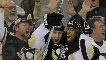 Georges Laraque celebrates after scoring in the second period against the Bruins at the Mellon Arena. (12/23/2007)