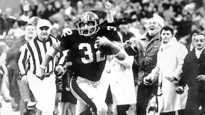 Franco Harris gives a goodbye look to an Oakland Raiders defender as he streaks down the sidelines for the winning touchdown after his "Immaculate Reception" in the 1972 AFC playoffs.