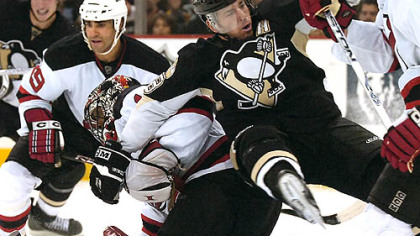 Mark Recchi collides with Devils goalie Kevin Weekes in the third period Monday night at Mellon Arena. (vs. New Jersey Devils 11/12/07)