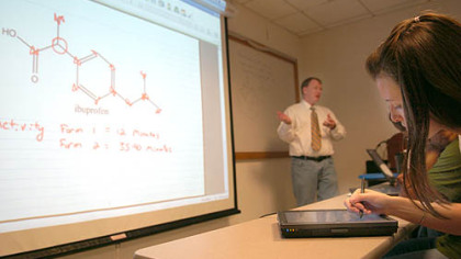 Jacqueline Regan, a junior chemistry major at Chatham University, takes notes on a tablet PC during Corey Stilts' organic chemistry class, which uses wireless Internet.