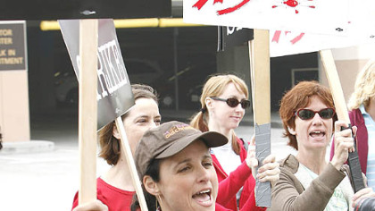 Actress Julia Louis-Dreyfus lends support to Writers Guild of America members as they picket Warner Bros. studios in Burbank, Calif., yesterday.