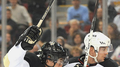 
Crosby is tied up by the Devils' Andy Greene.