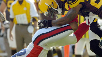 Steelers cornerback Bryant McFadden and free safety Anthony Smith take down Bills Lee Evans late in the game.