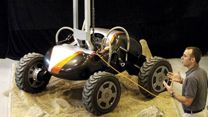 David Wettergreen, associate research professor of robotics at CMU, introduces Scarab, a four-wheeled robot for lunar prospecting, to the media during a news conference yesterday. Scarab will never leave Earth. It is intended to demonstrate technologies that a lunar rover will need.