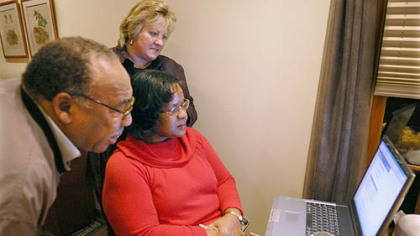 Cheryl Allen follows results on a computer Tuesday night with Jimmie Skipwith, her husband, and campaign manager Anne Palmer.