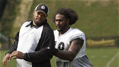 Max Starks, right, works on blocking techniques with assistant offensive line coach Harold Goodwin Aug. 1.