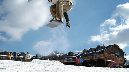 Even the more adventurous snow sport enthusiasts can find their niche at Nemacolin Woodlands Mystic Mountain complex. Here, a snowboarder catches air in front of the Sundial Lodge.