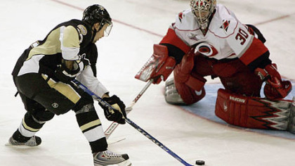 Petr Sykora, left, of the Czech Republic, skates in on Carolina Hurricanes goalie Cam Ward to score in the shootout of the hockey game in Pittsburgh last night. Sykora had two goals in regulation.