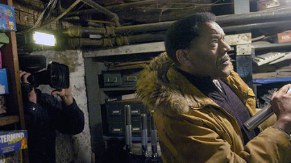 John Ford, curator at the Heinz History Center and Underground Railroad expert, examines the basement of the Jacob Witzel House on Evergreen Road during a taping of an episode of A&E's "Paranormal U" series on Saturday, December 9, 2006.